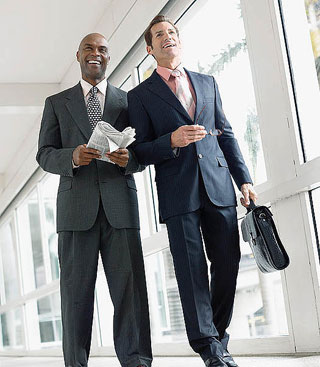 two businessmen talking and smiling